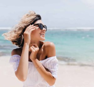 relaxed-short-haired-woman-posing-beach-scaled-1